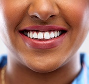 A woman’s smile with a small gap between the two front teeth before porcelain veneers