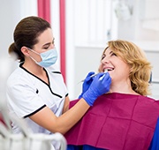 patient smiling while visiting dentist 