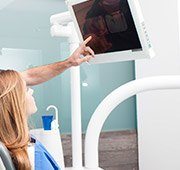 Dentist and patient looking at intraoral photos