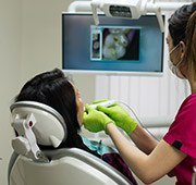 Patient and dentist looking at intraoral photos