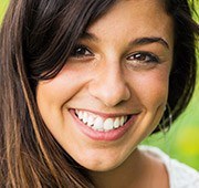 Young woman with flawless smile after cosmetic dentistry