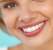 closeup of patient smiling after getting dental crown 