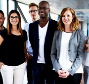 A group of working professionals smiling.