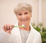 Woman brushing teeth in Salem