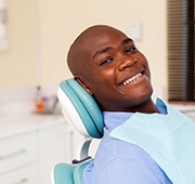 man smiling after getting dental implants in Salem