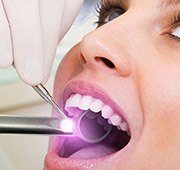 Woman receiving oral cancer screening