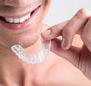 A man using a teeth whitening tray
