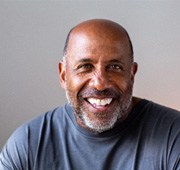 Man in blue shirt smiling at camera