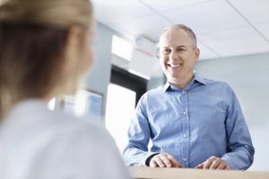 A man smiling at the dental office.