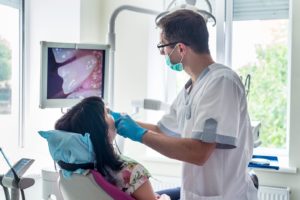 dentist using intraoral camera