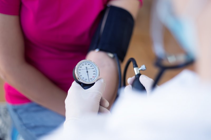 an up-close image of a person having their blood pressure taken