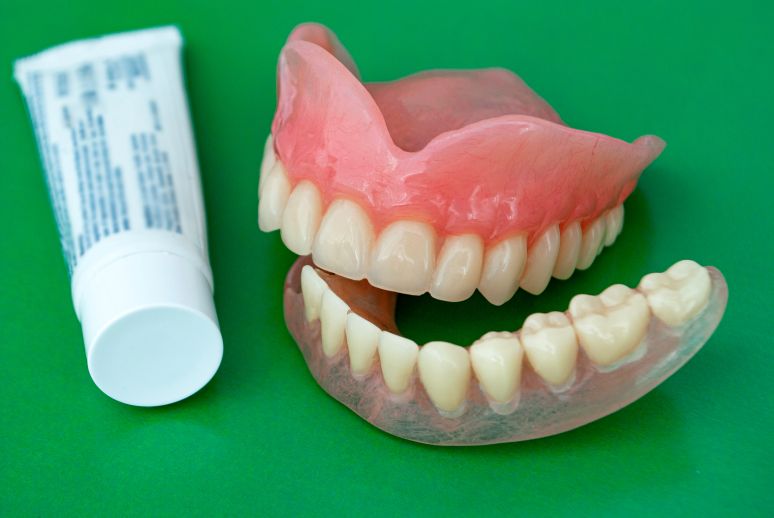 Dentures and denture adhesive